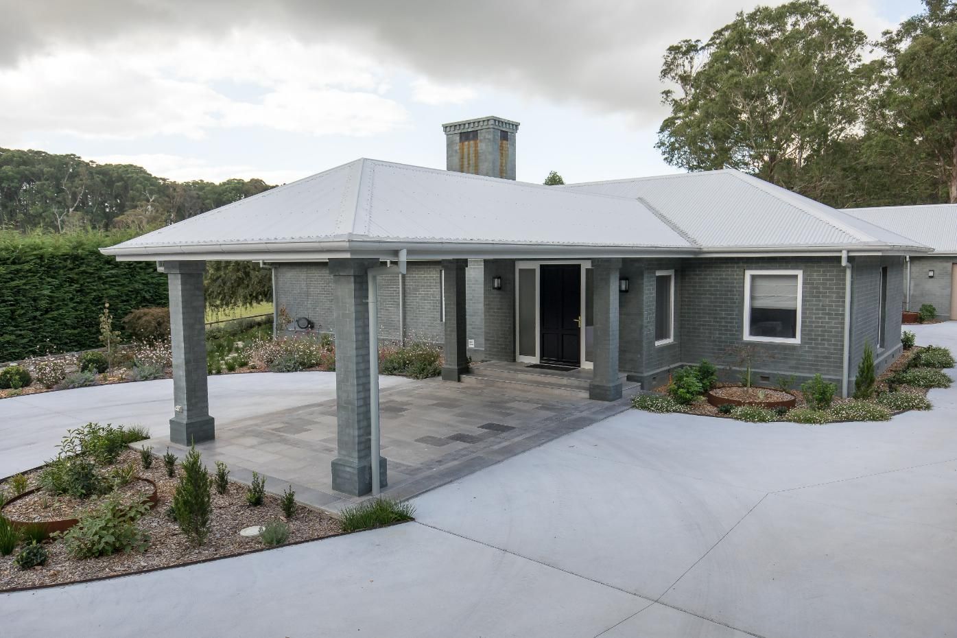 A Gray House with A White Roof and A Driveway — GMT Builders Pty Ltd in Kangaloon, NSW