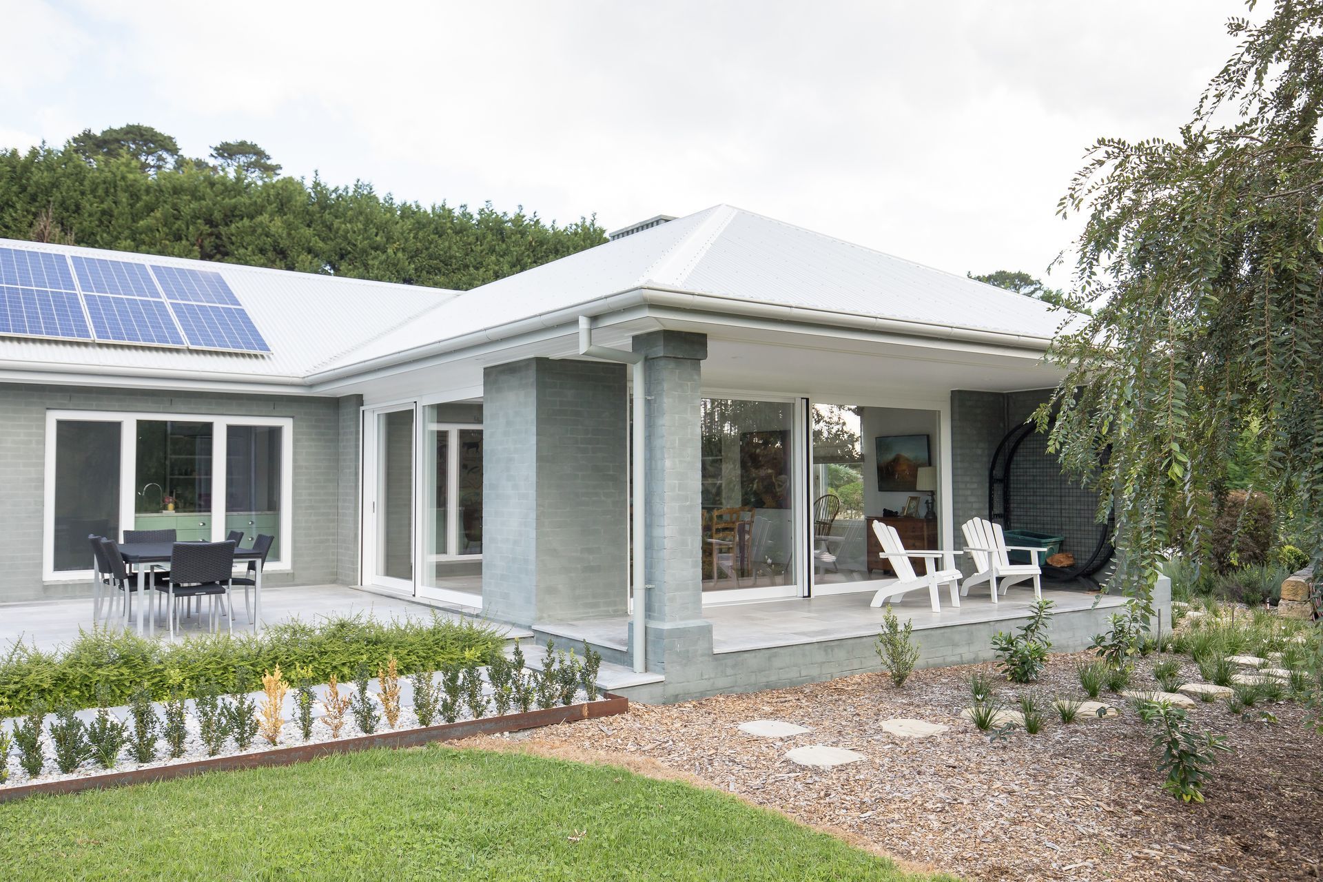 A house with a patio and solar panels on the roof   — GMT Builders Pty Ltd in Berrima, NSW