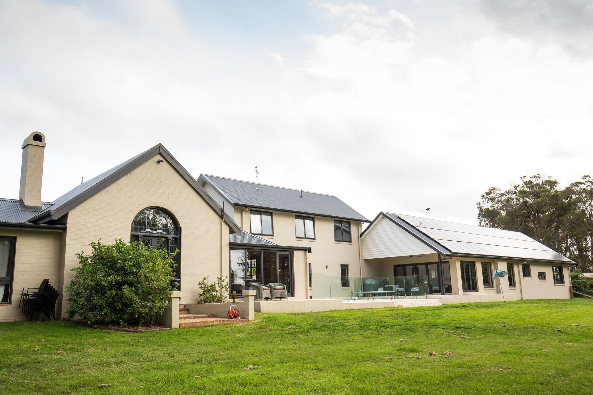 A House with A Patio and Solar Panels on The Roof — GMT Builders Pty Ltd in Berrima, NSW