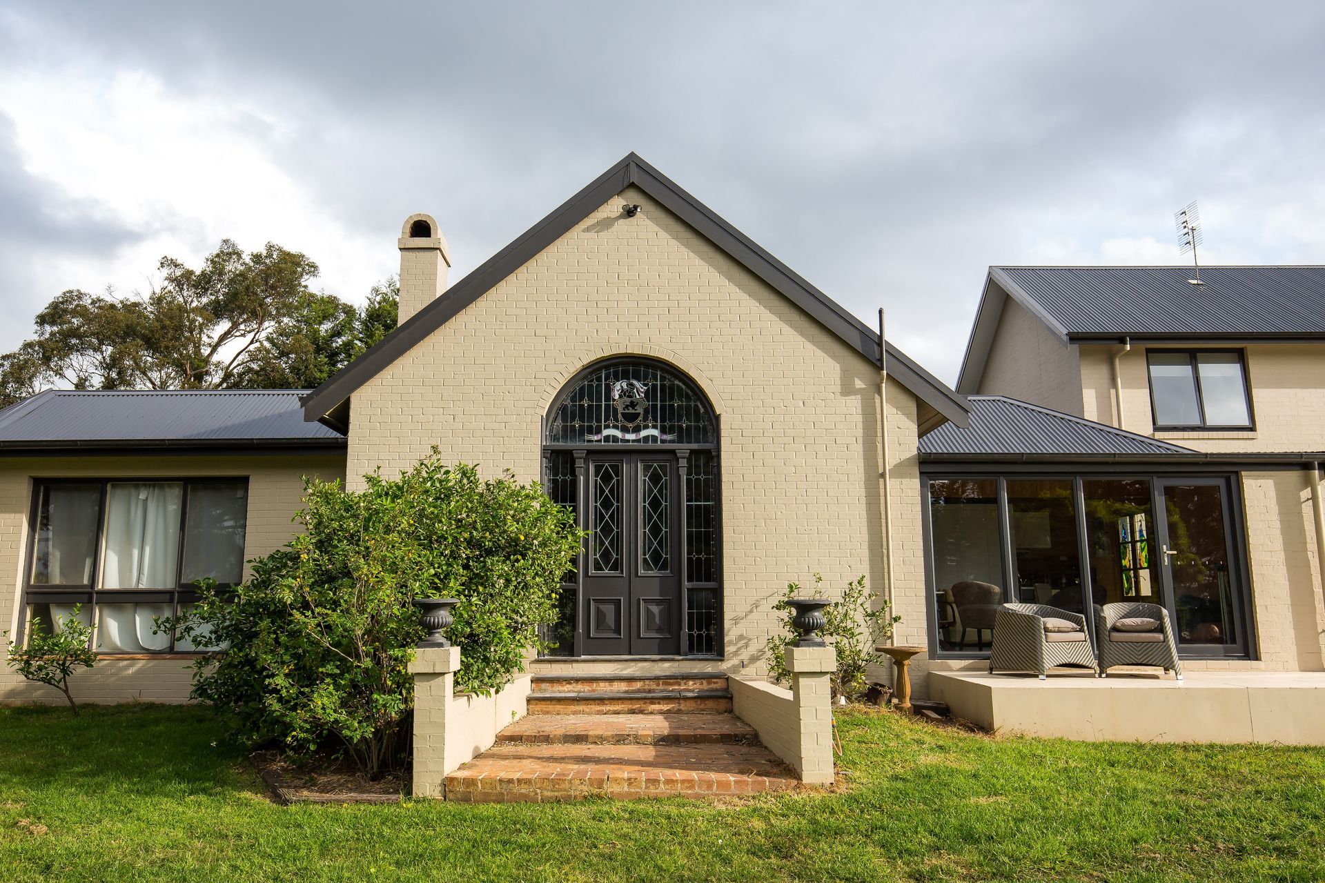 A large house with a lush green lawn in front of it — GMT Builders Pty Ltd in Berrima, NSW