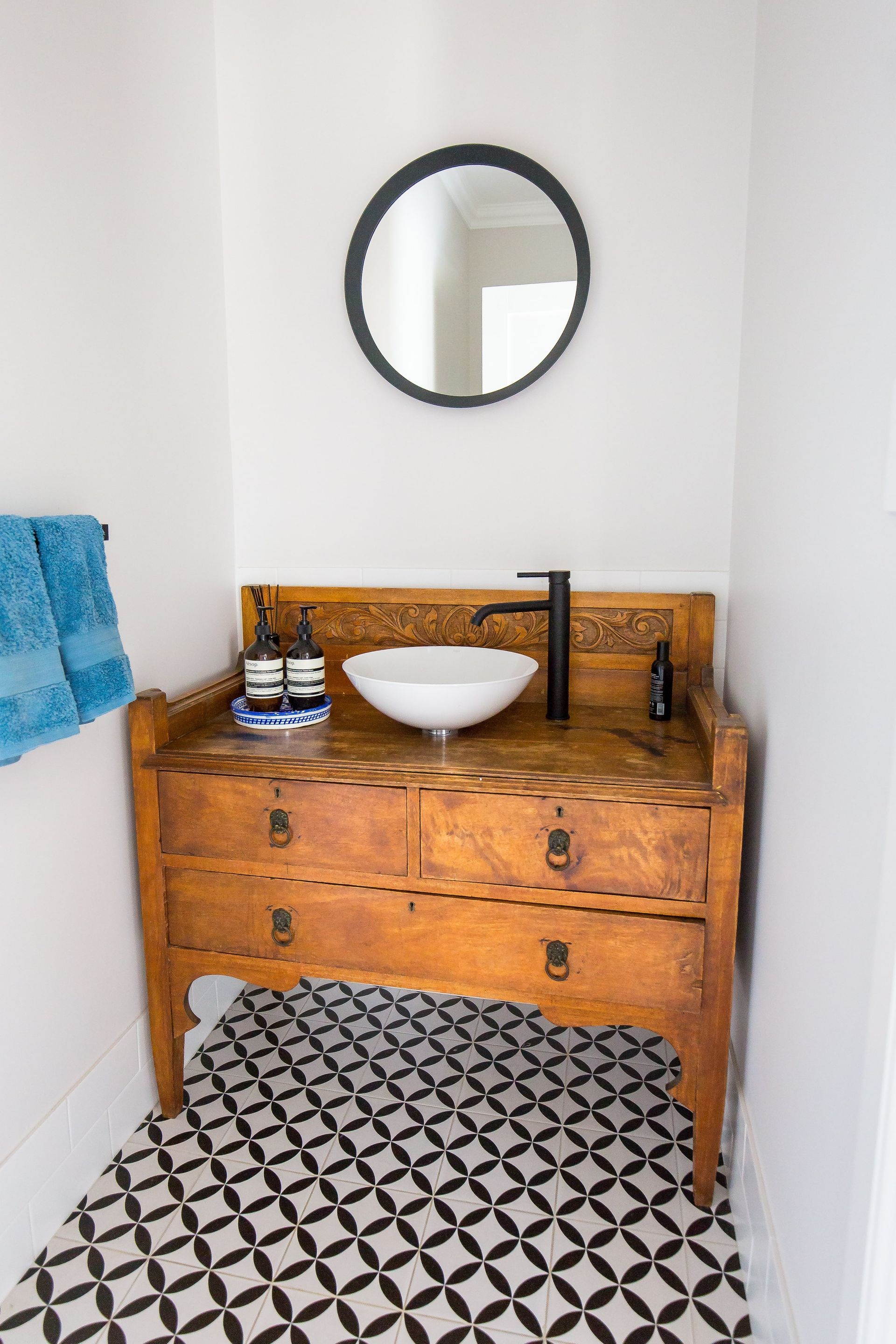 A bathroom with a wooden vanity, sink and mirror — GMT Builders Pty Ltd in Berrima, NSW