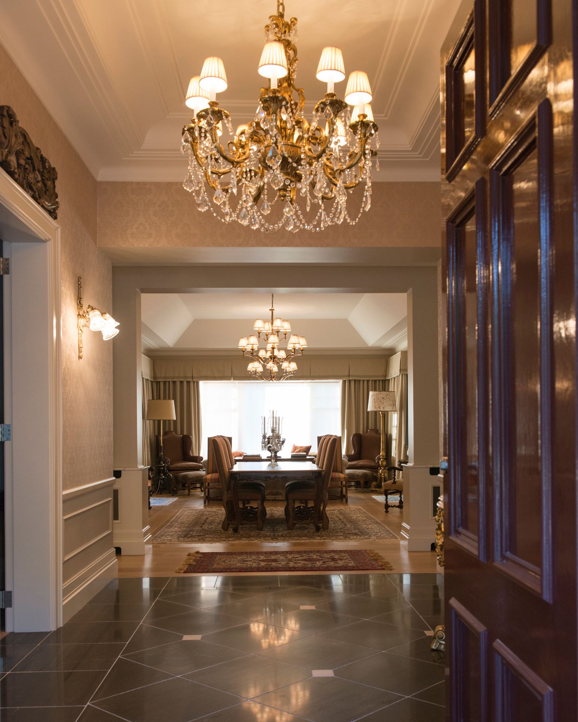A hallway with a chandelier hanging from the ceiling — GMT Builders Pty Ltd in Bowral, NSW