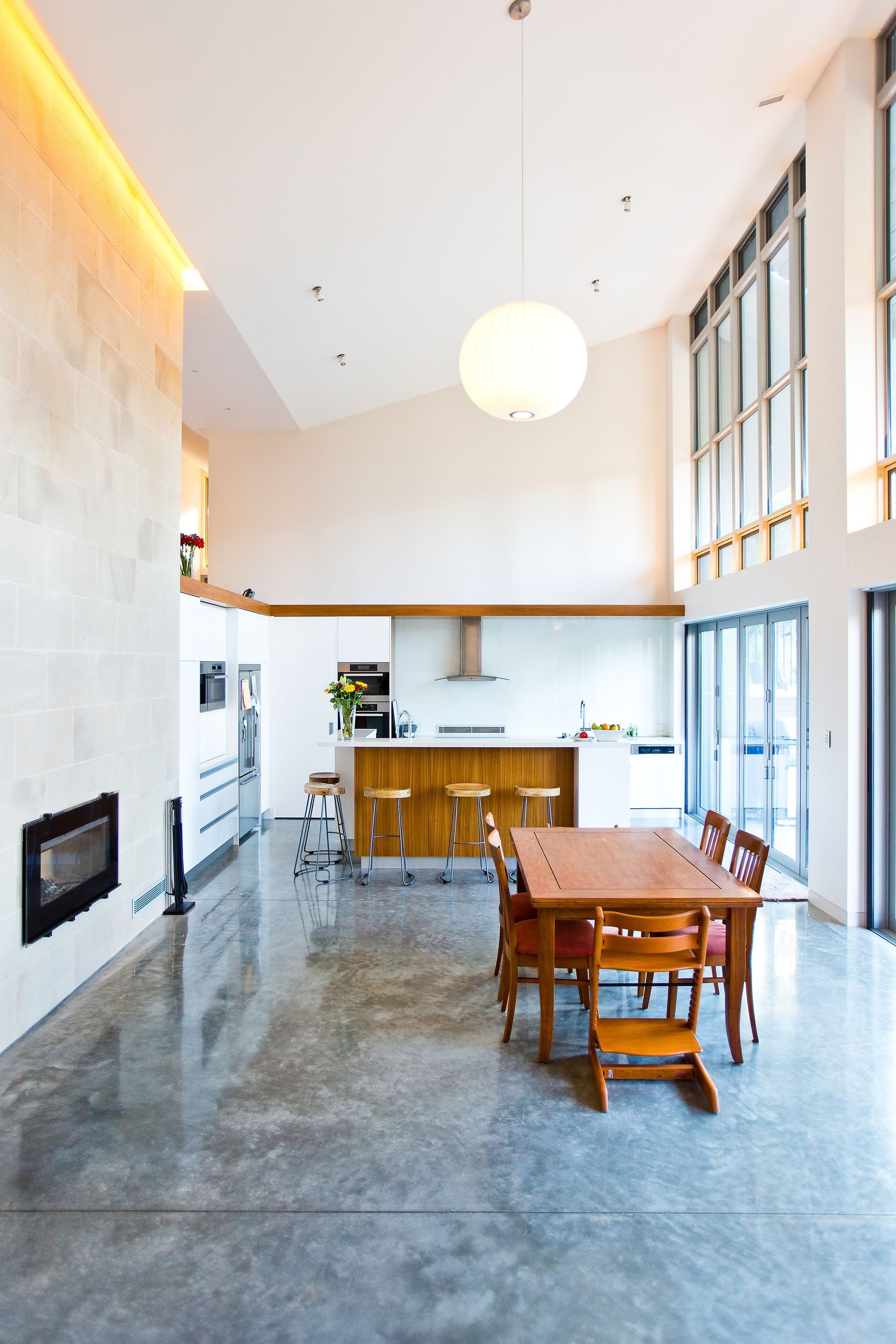 A large room with a table and chairs in it — GMT Builders Pty Ltd in Sunninghill, NSW