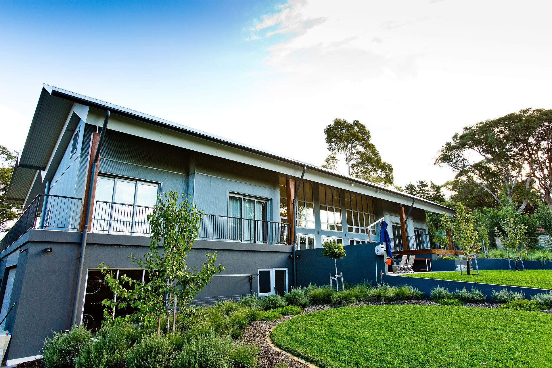 A Kitchen with Green Cabinets , a Stove , and A Clock on The Wall — GMT Builders Pty Ltd in Berrima, NSW