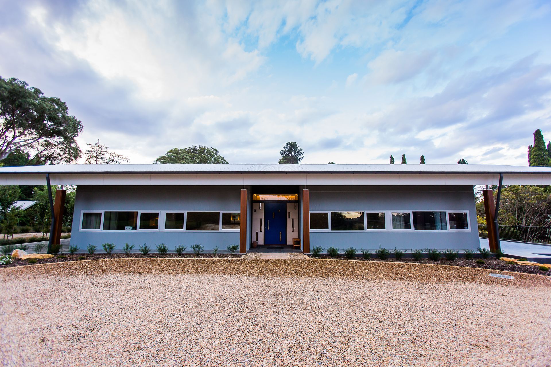 A house with a blue door and a lot of windows — GMT Builders Pty Ltd in Sunninghill, NSW