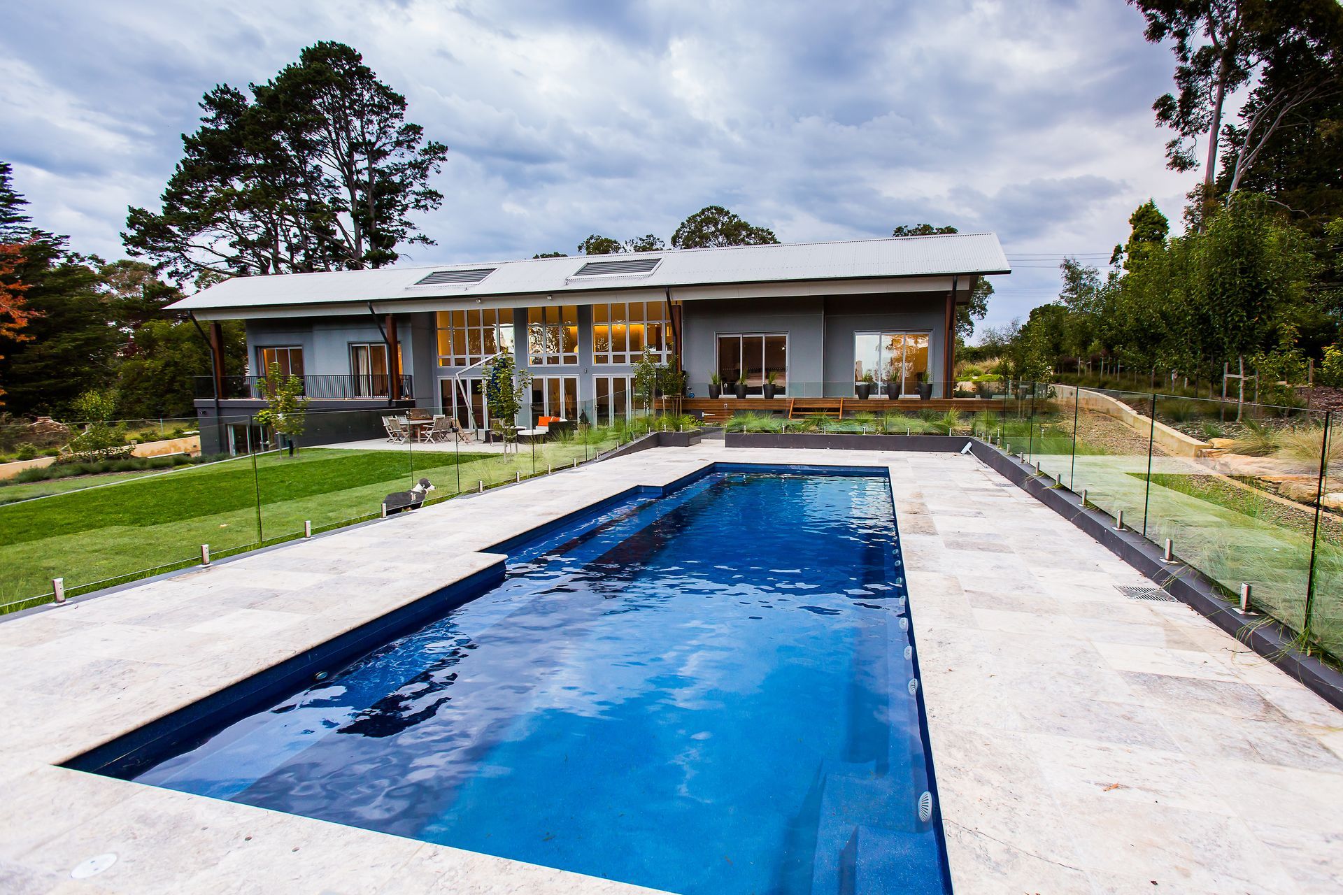 A large house with a large swimming pool in front of it — GMT Builders Pty Ltd in Sunninghill, NSW