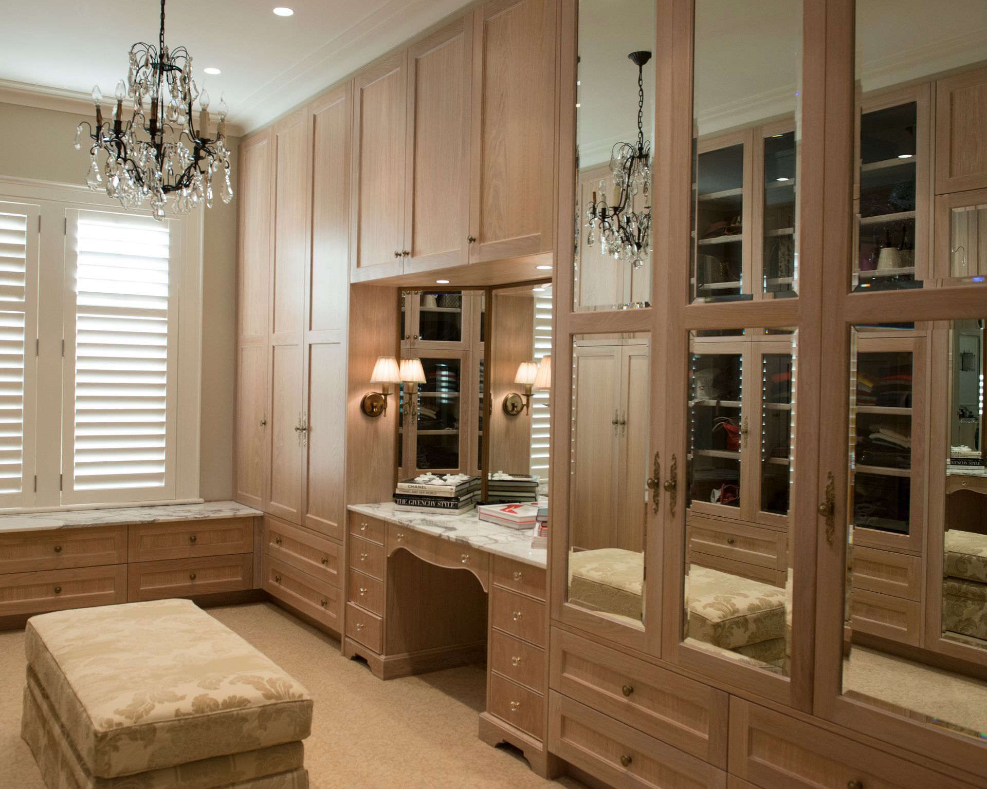A walk in closet with lots of cabinets and mirrors — GMT Builders Pty Ltd in Bowral, NSW