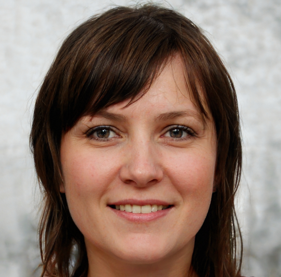 Blonde woman with blue eyes smiles slightly, wearing pearl earrings, close-up portrait.