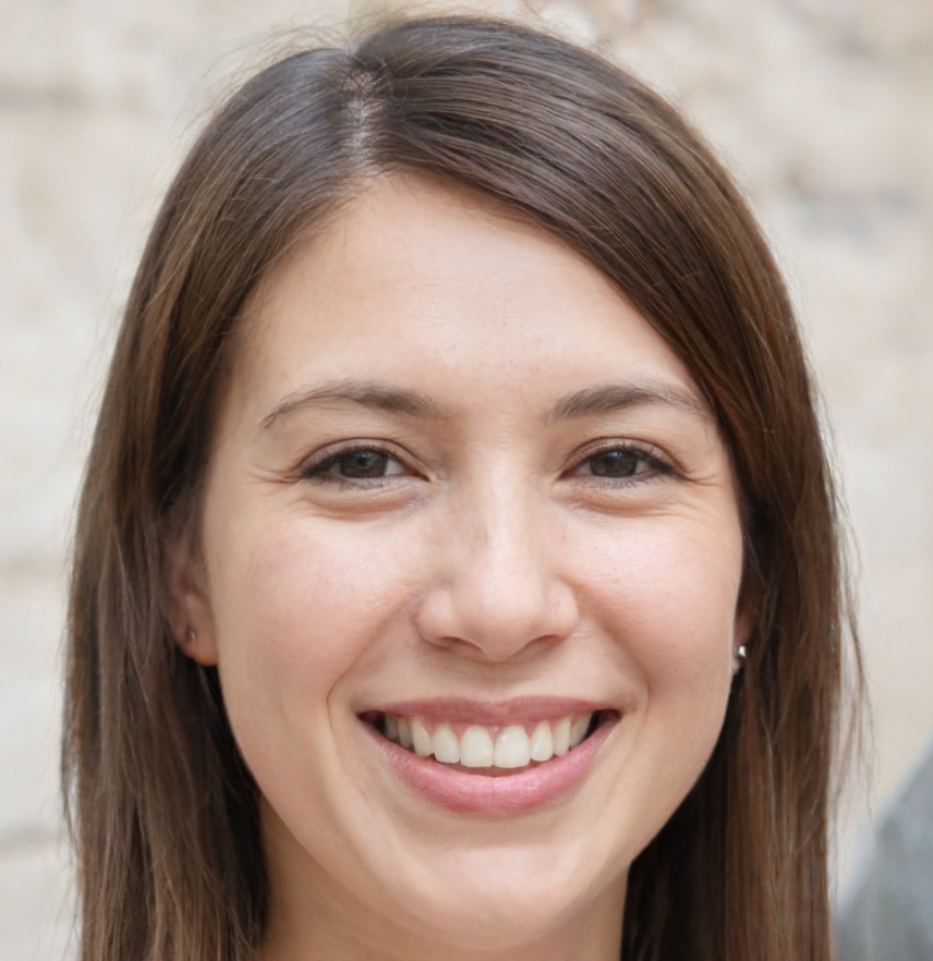 Woman with brown hair smiles at the camera, wearing a white shirt.
