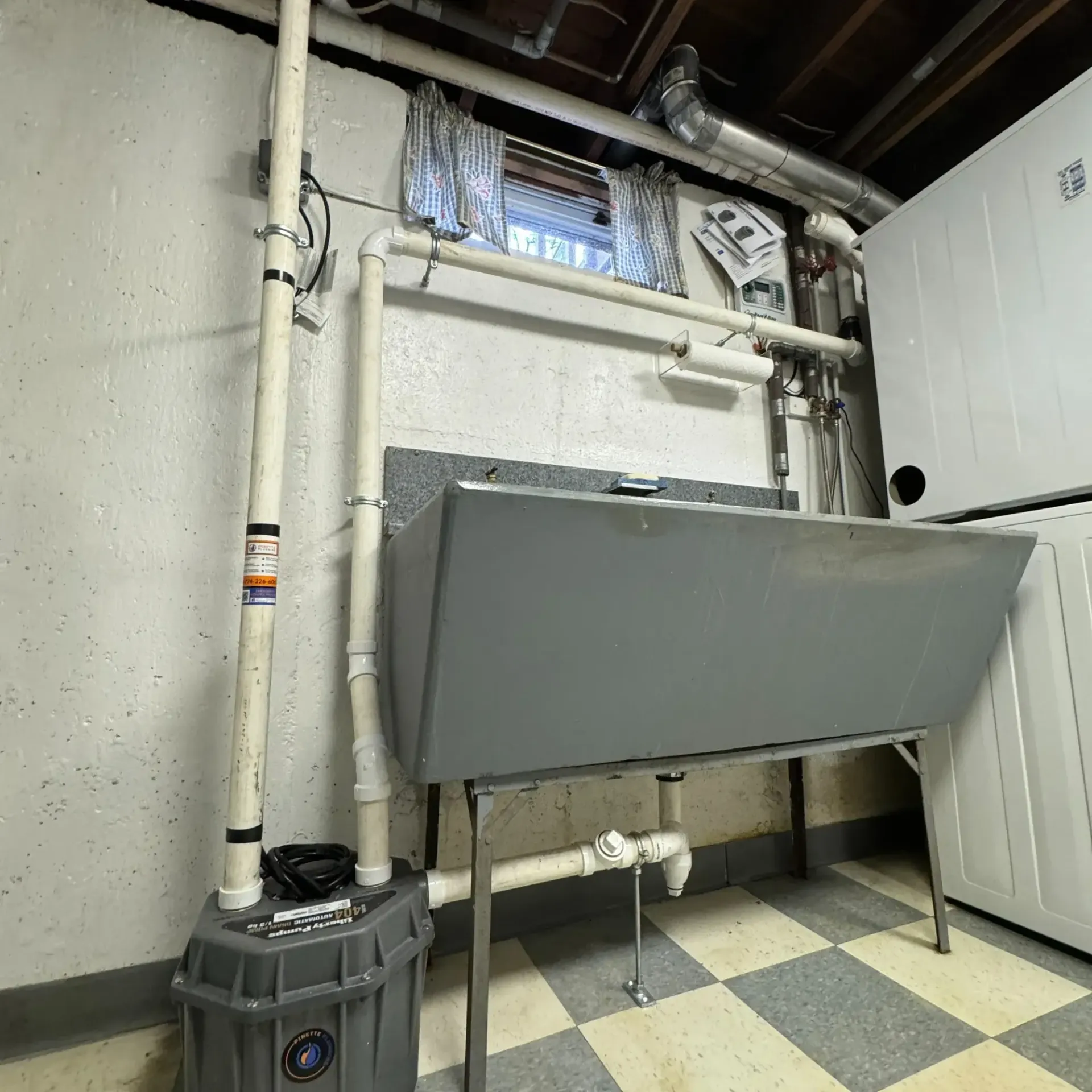 Pinette Plumbing - A laundry room with a sink and a window