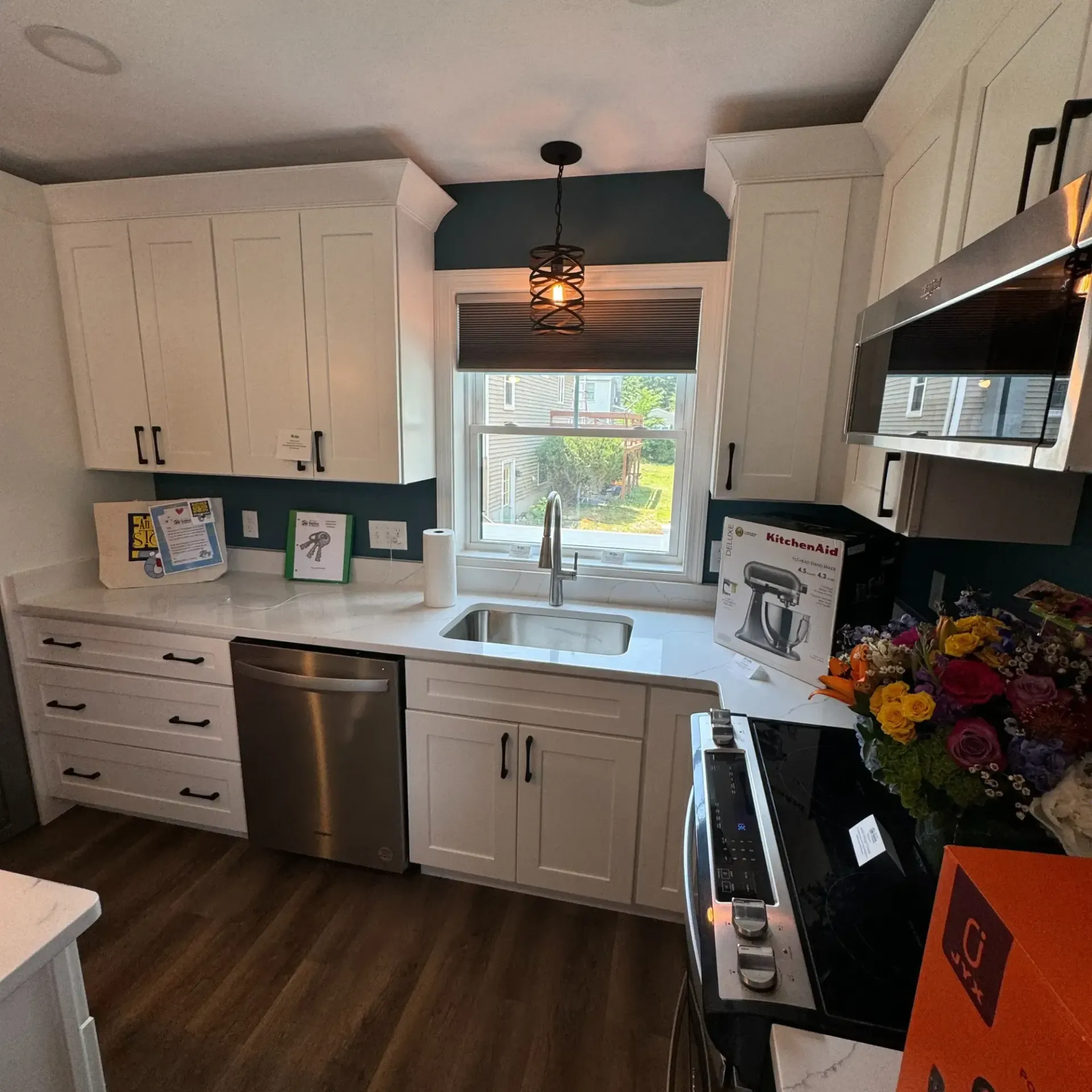 Pinette Plumbing - A kitchen with white cabinets and stainless steel appliances