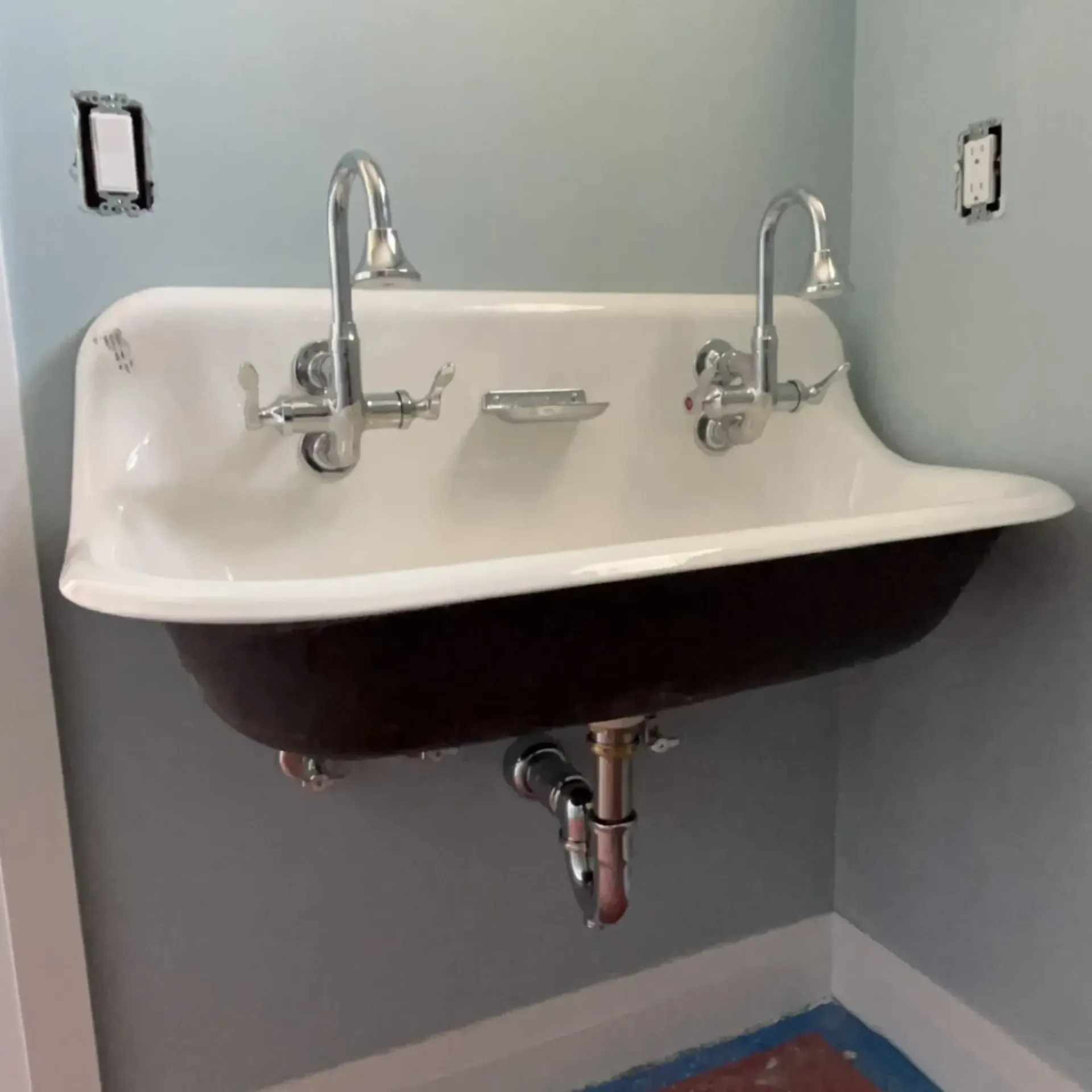 Pinette Plumbing - A bathroom sink with two faucets and a soap dish