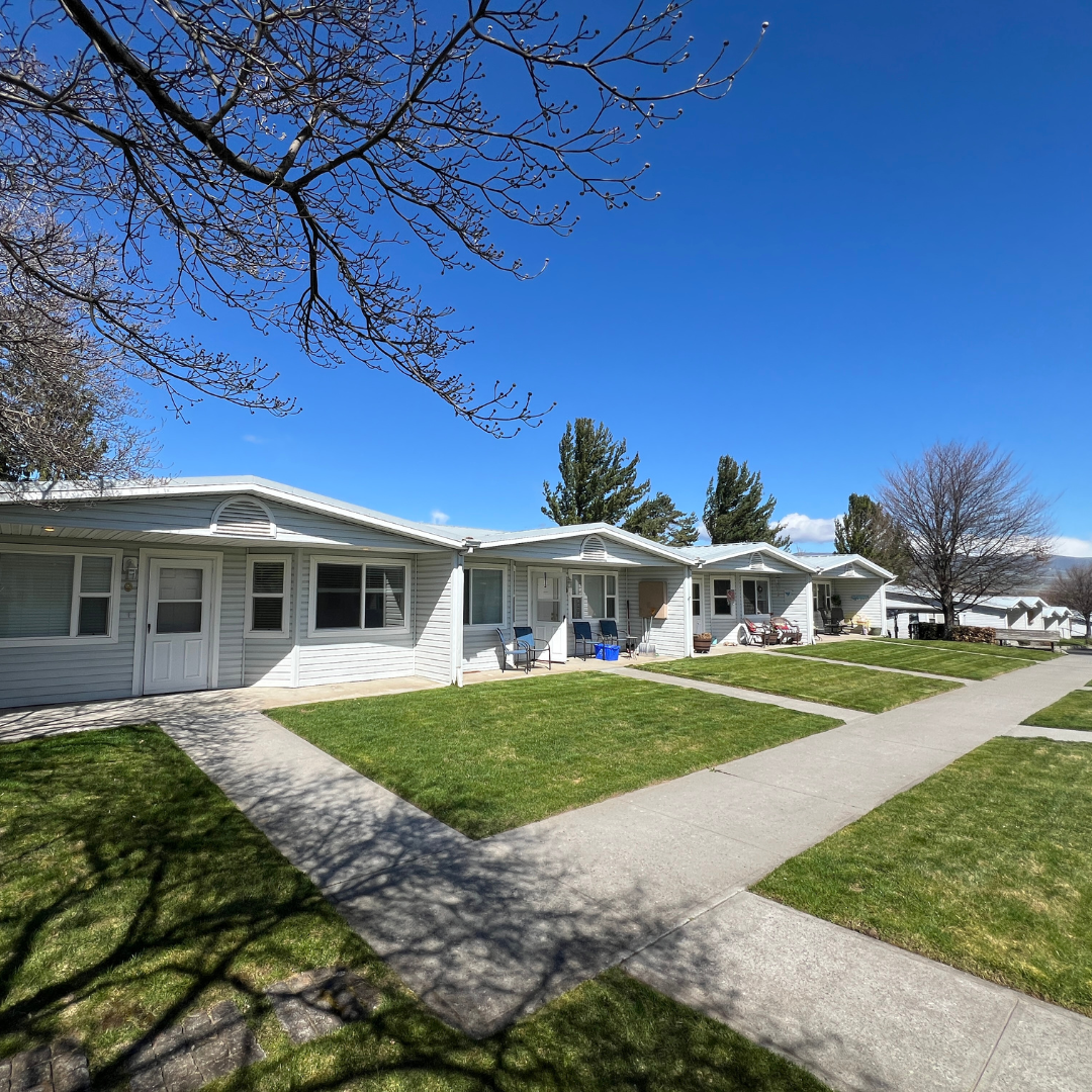A row of houses are lined up next to each other on a sunny day.