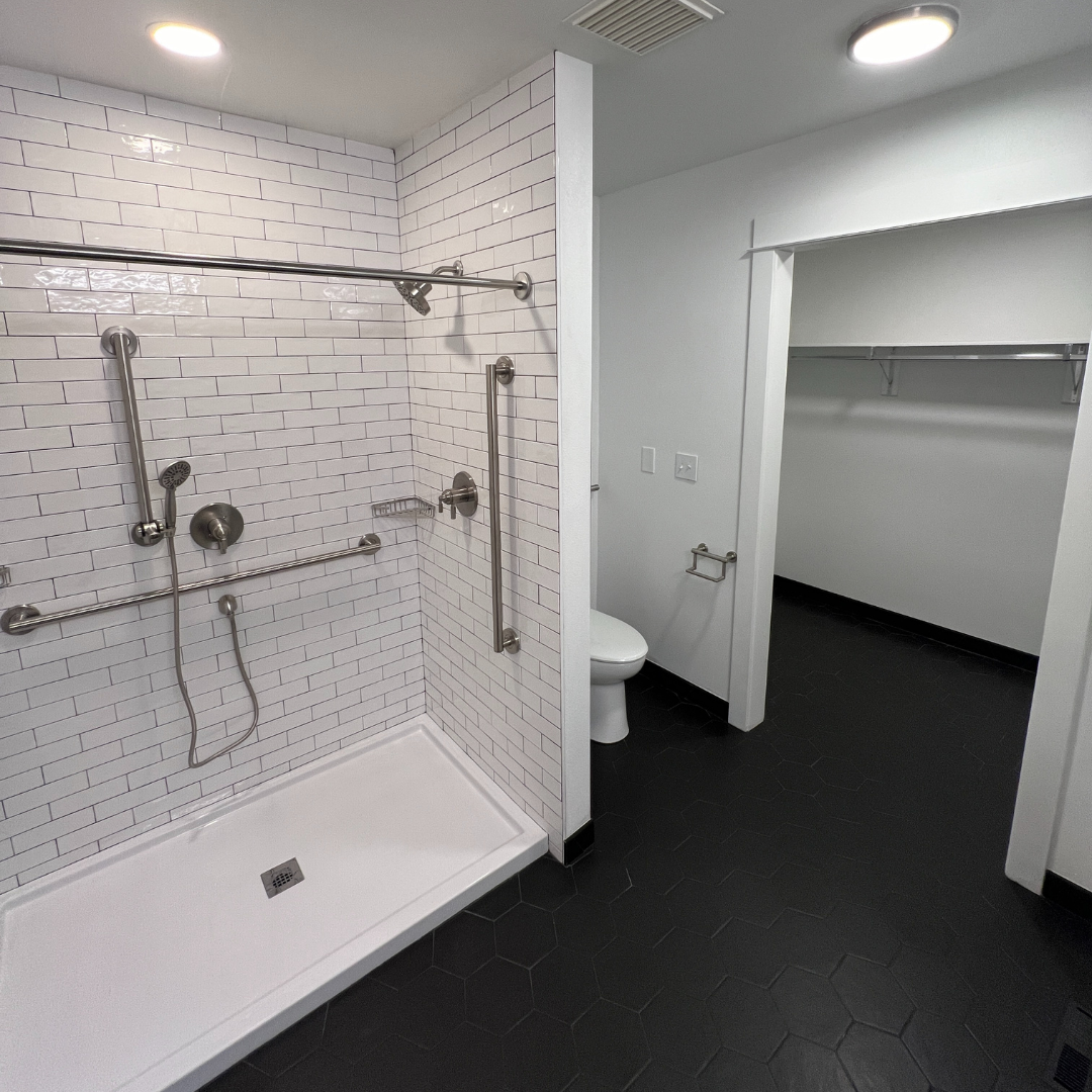 A bathroom with a walk in shower and a toilet.