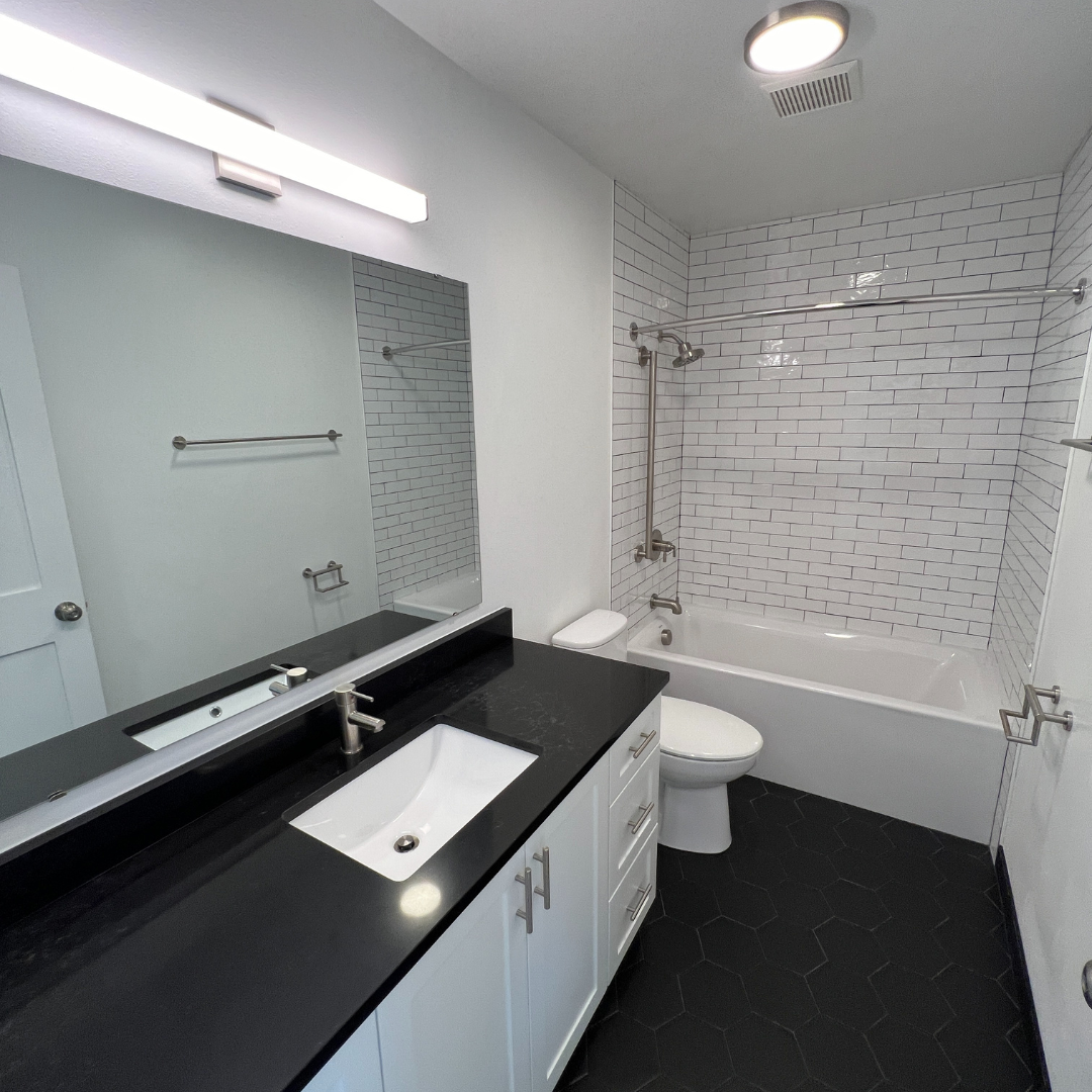 A bathroom with a sink a toilet and a bathtub