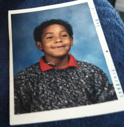 A picture of a young boy with a red collar