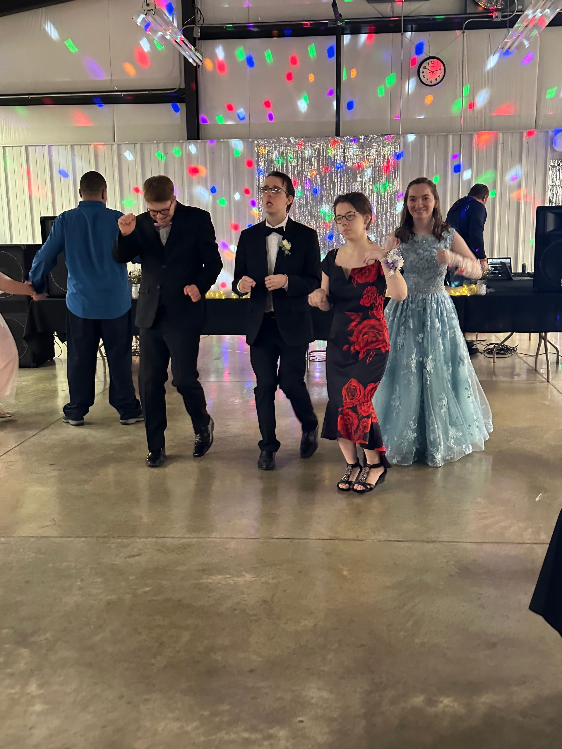 A group of people are dancing together in a room.