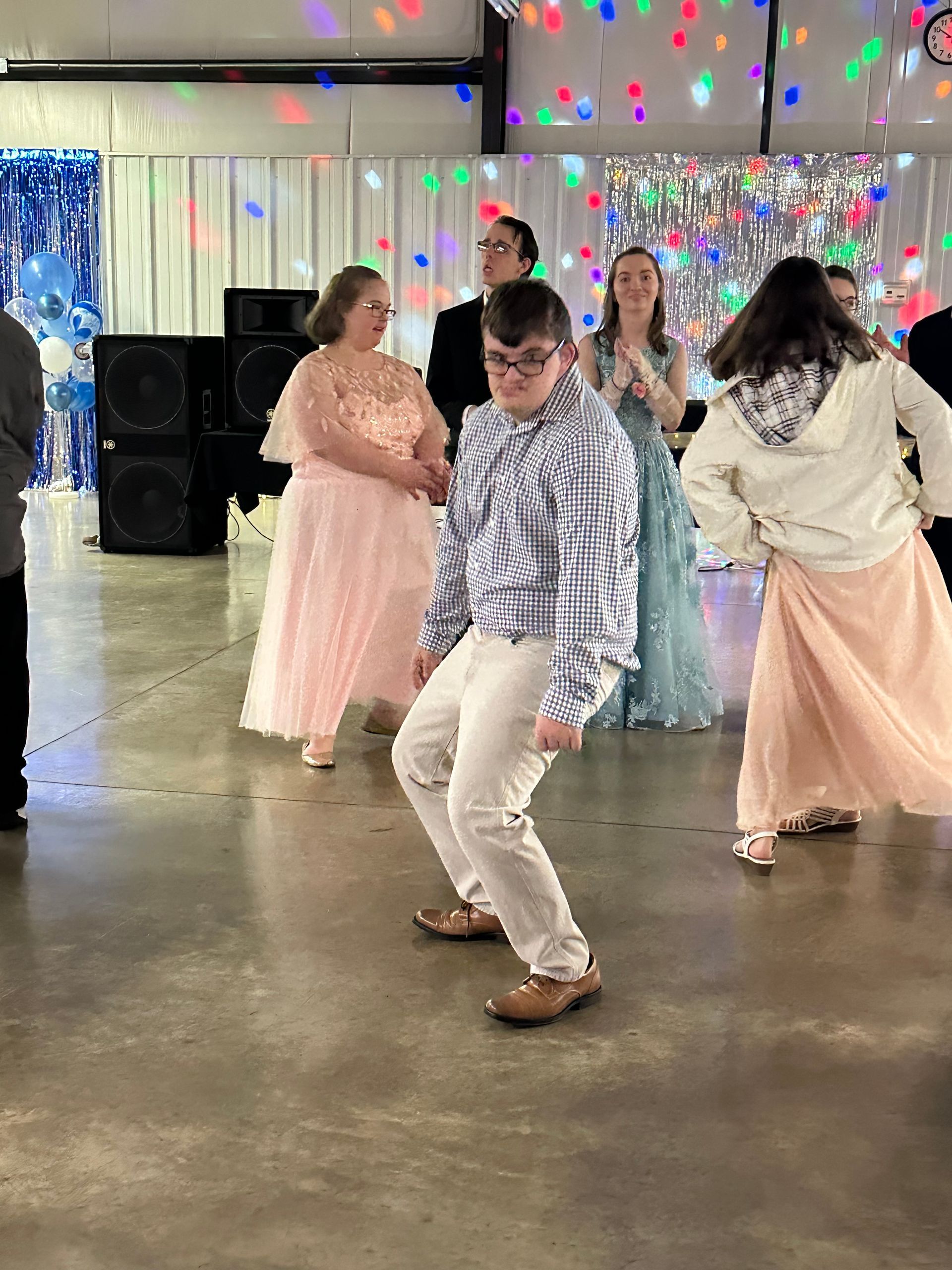 A group of people are dancing in a room.