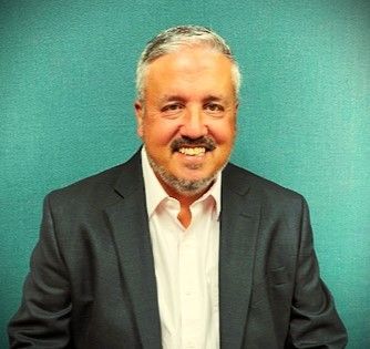 A coming soon sign with a camera in a circle on a white background.