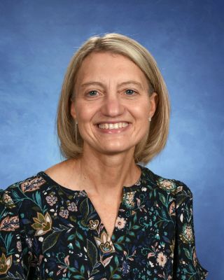 A woman is wearing a green old navy sweatshirt and smiling.