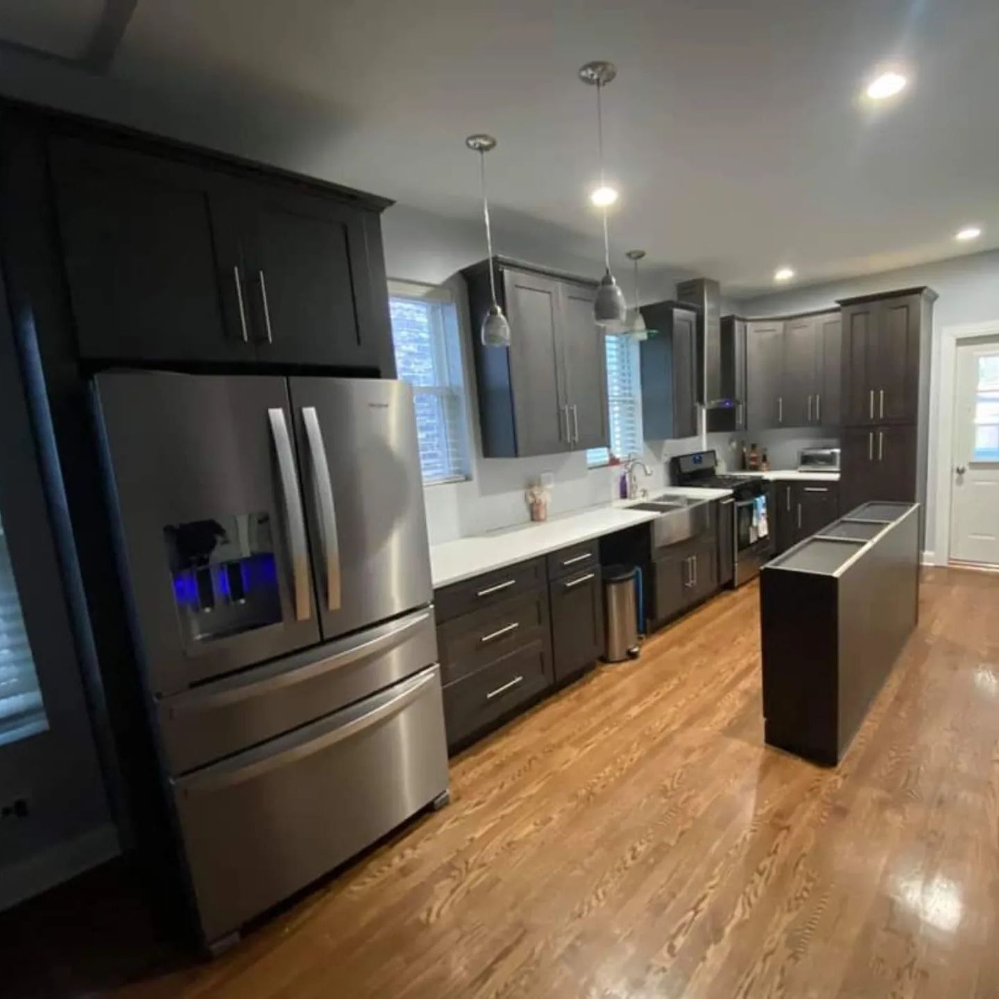 A kitchen with stainless steel appliances and wooden cabinets