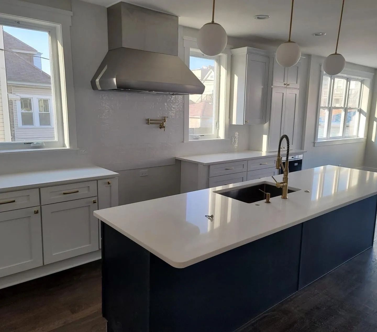 A kitchen with stainless steel appliances and wooden cabinets.