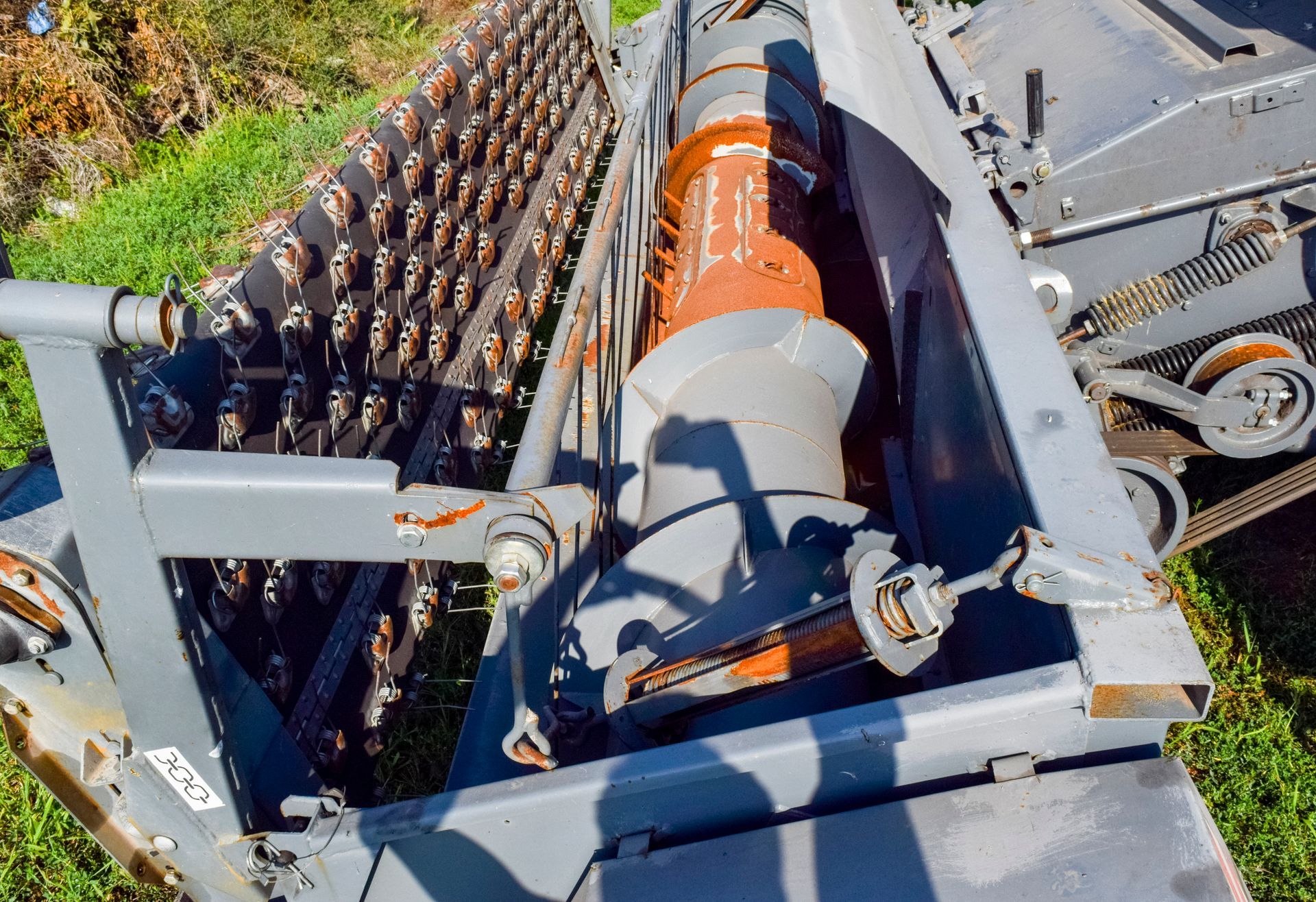 A close up of a machine with a shadow on the ground