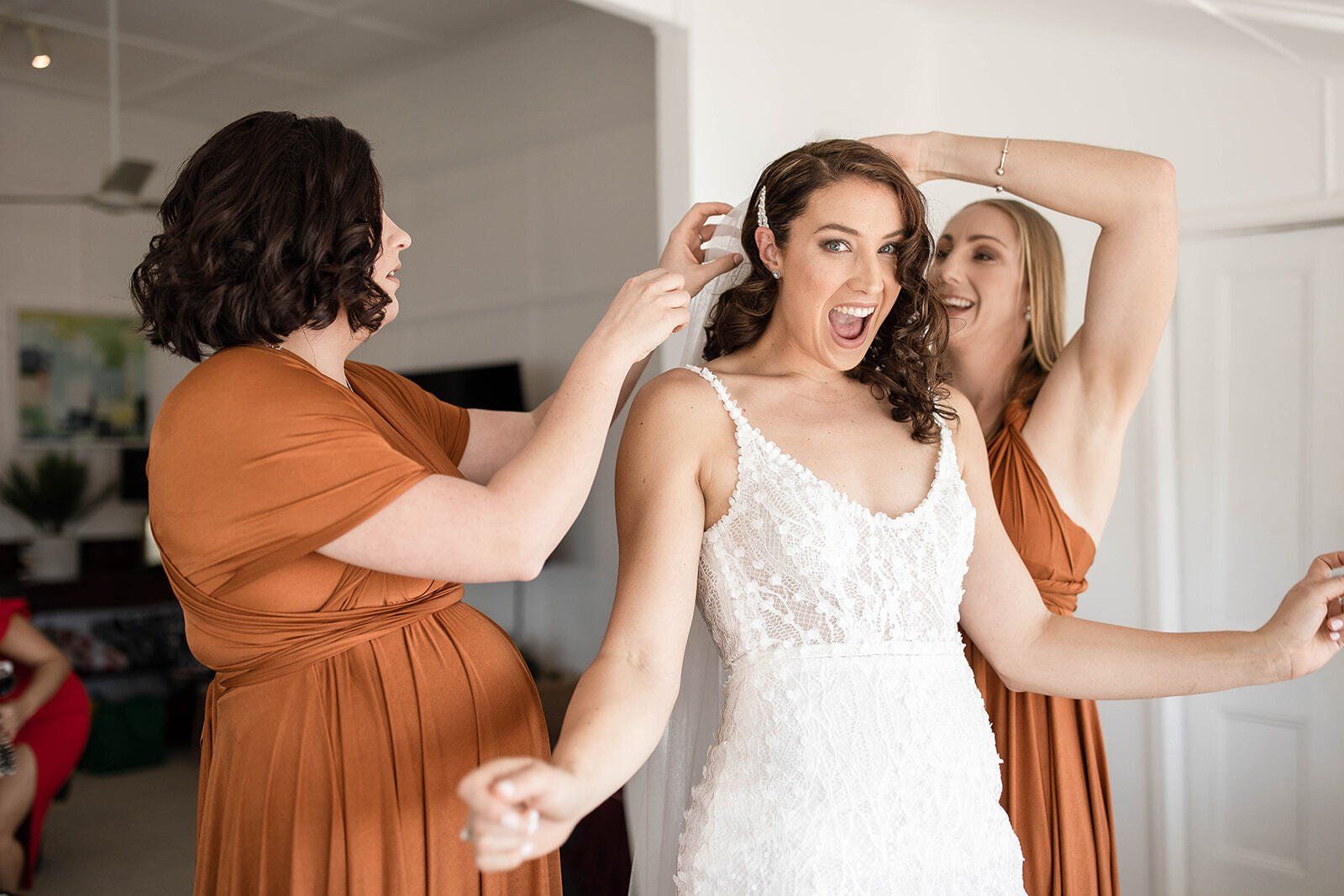 A bride and her bridesmaids are getting ready for her wedding.