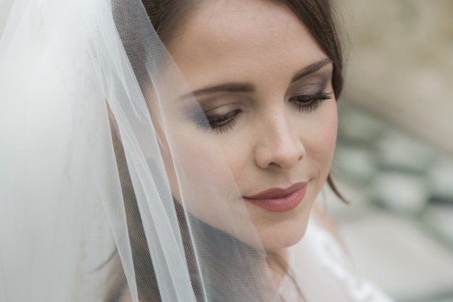 A close up of a woman wearing a veil on her head.