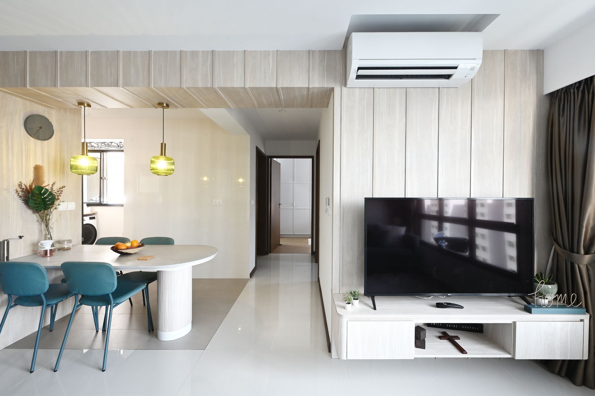 A living room with a table and chairs and a flat screen tv.