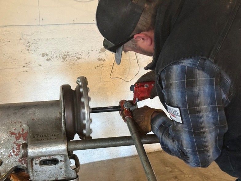 A technician uses a maintenance item to check the cabling of a furnace. A technician uses a maintenance item to check the cabling of a furnace.