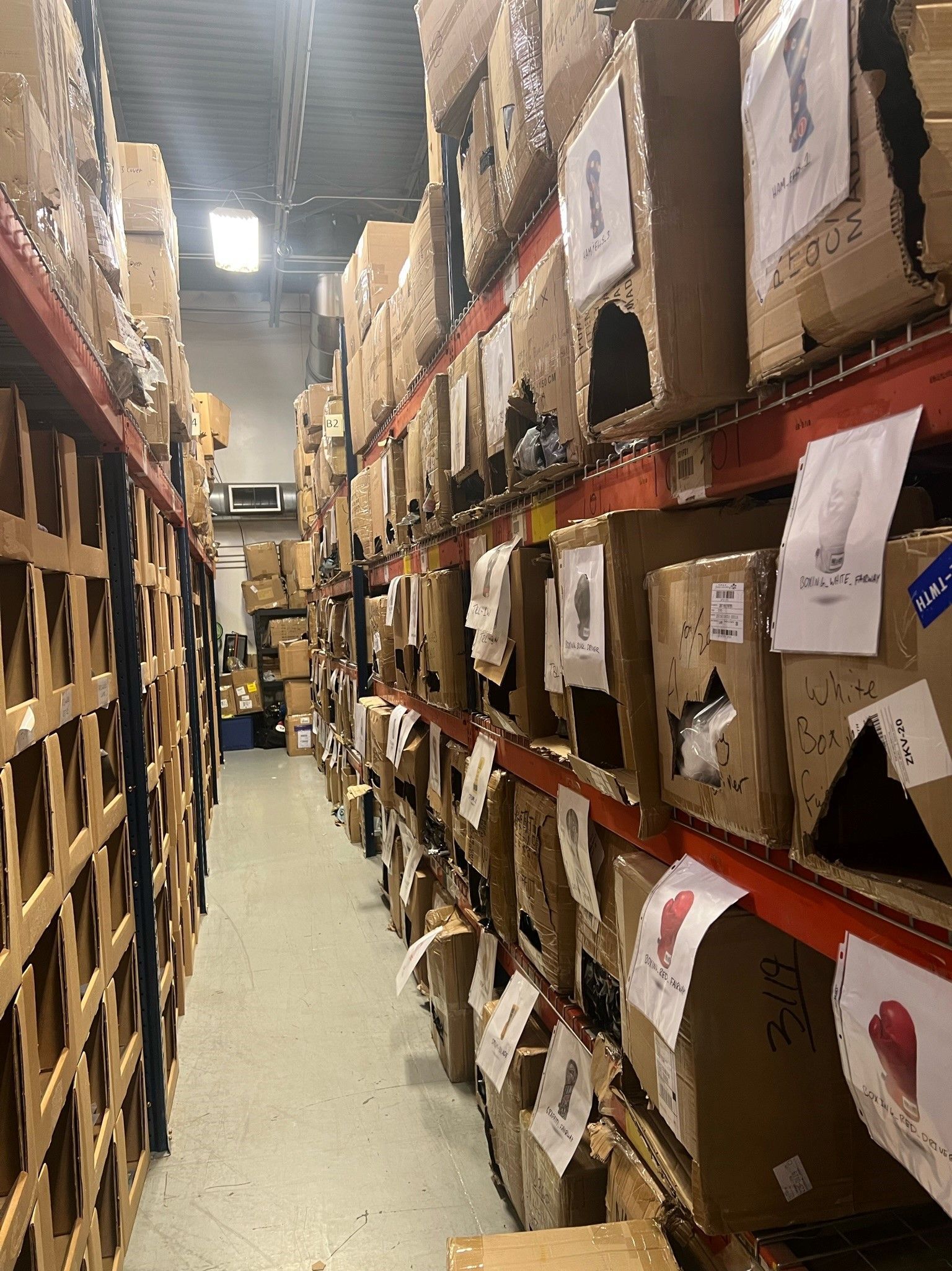 A warehouse filled with lots of cardboard boxes on shelves.