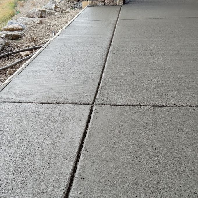 Newly poured concrete patio with control joints.