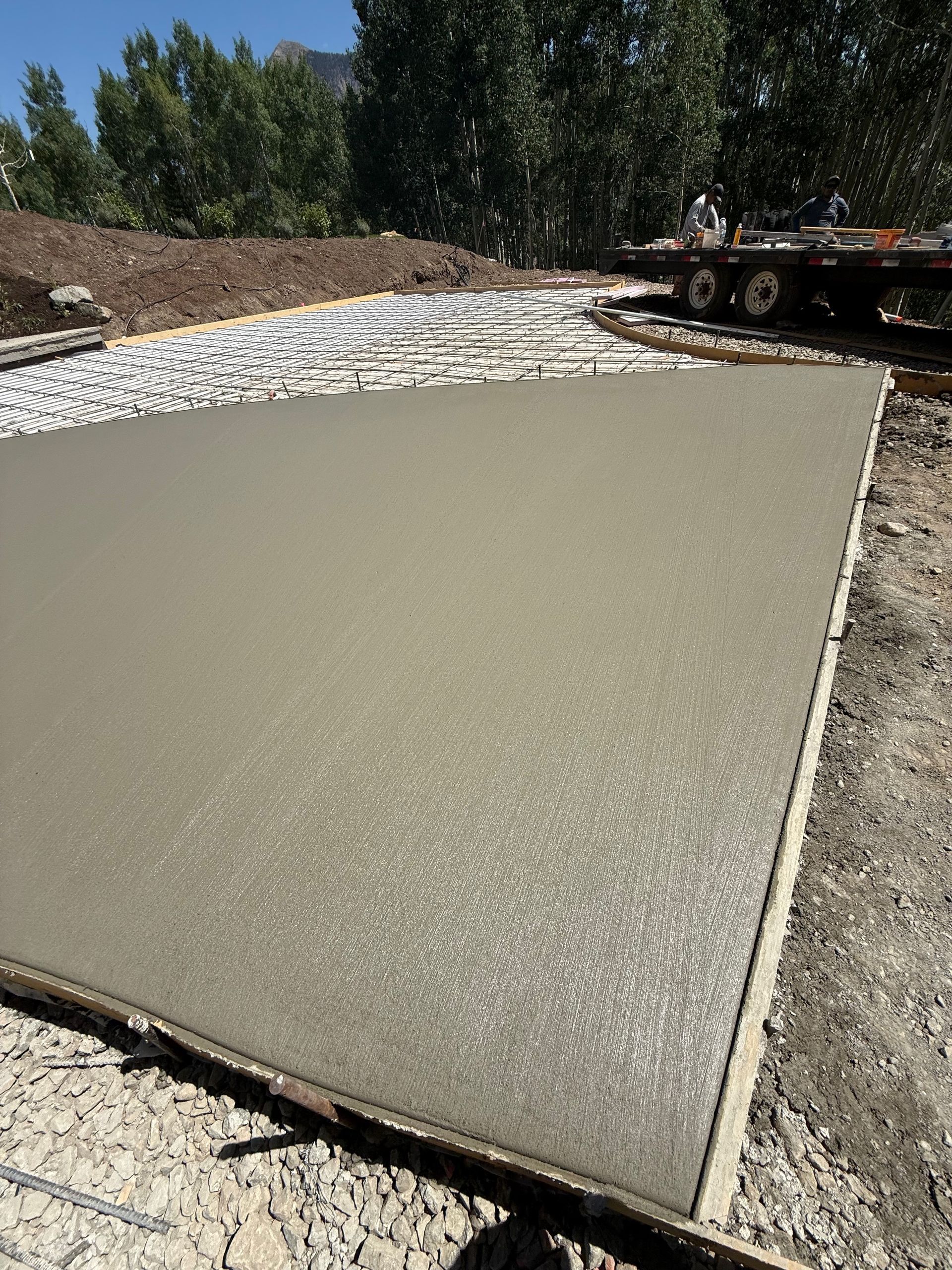 Freshly poured concrete slab in outdoor construction site.