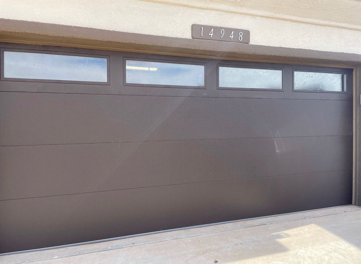 Brown garage door with windows above and house numbers 12349.