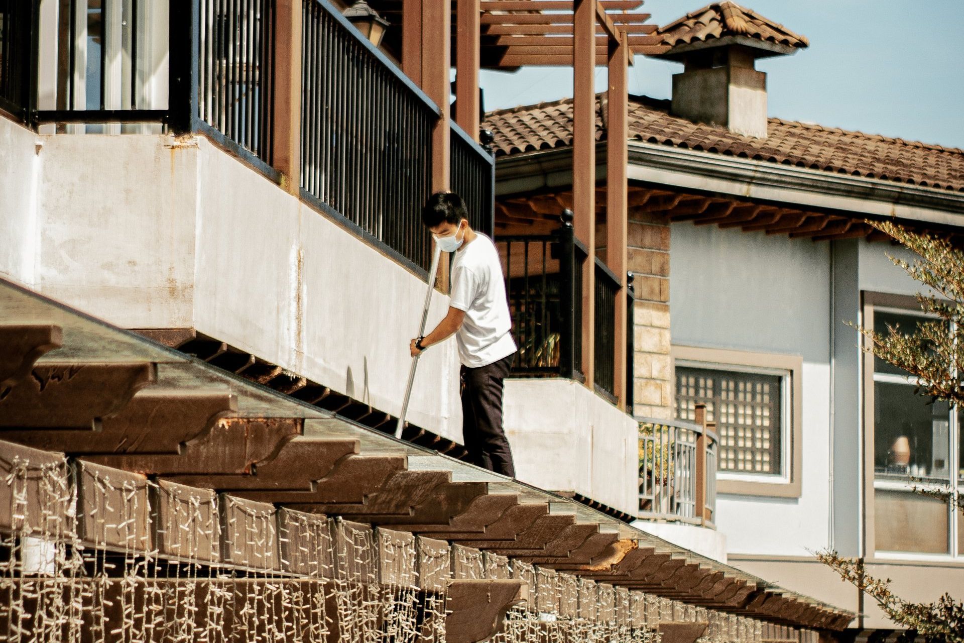 image of person cleaning the roof