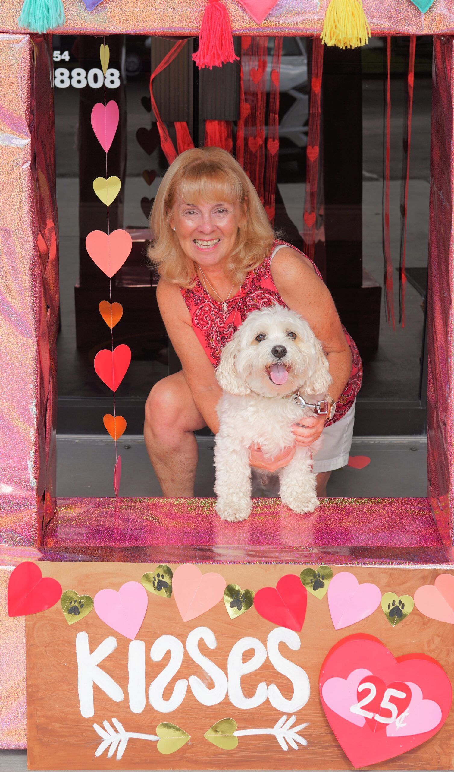 Lakeside customer and puppy patient posing for their kissing booth photo