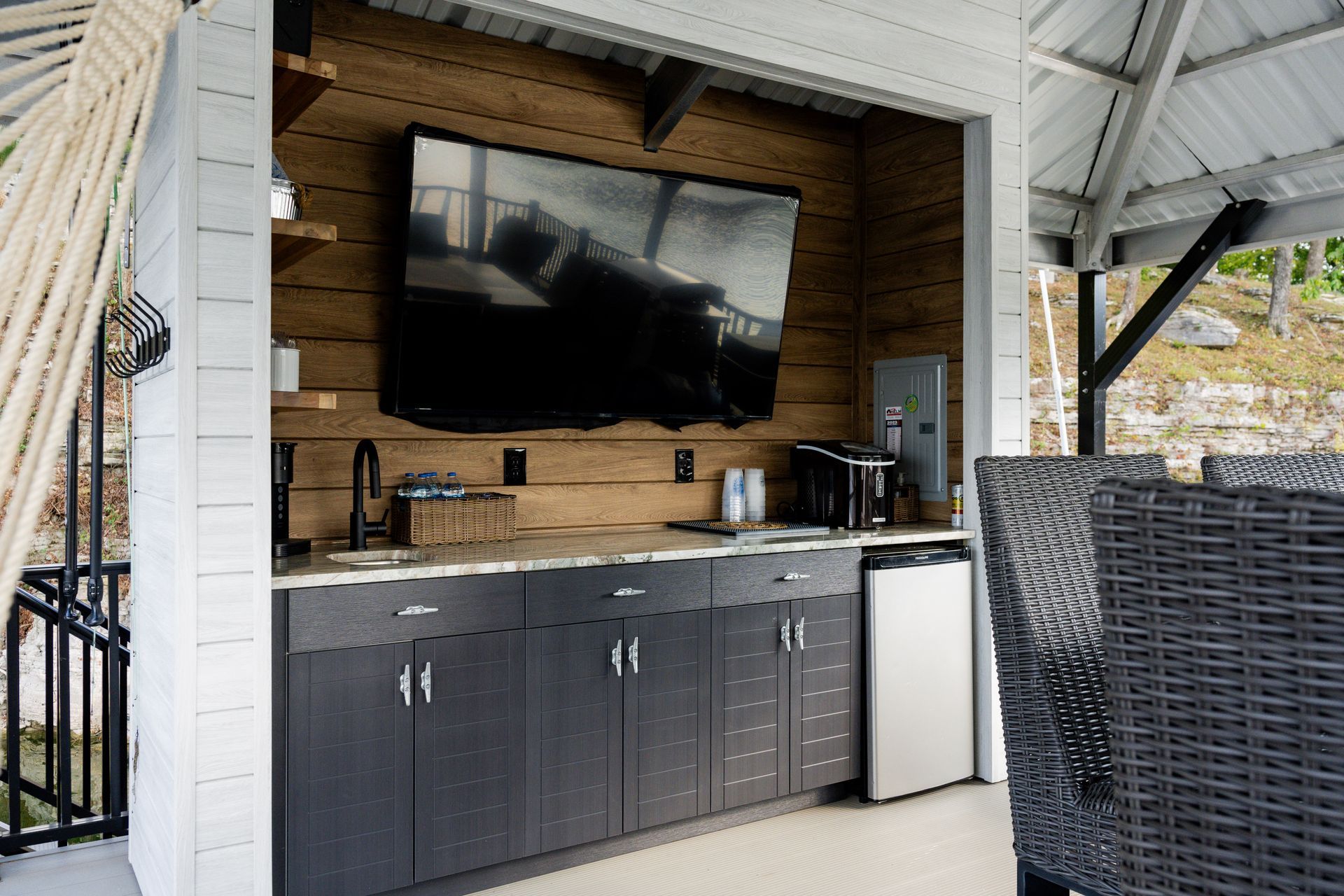 A kitchen with a large flat screen tv mounted on the wall.