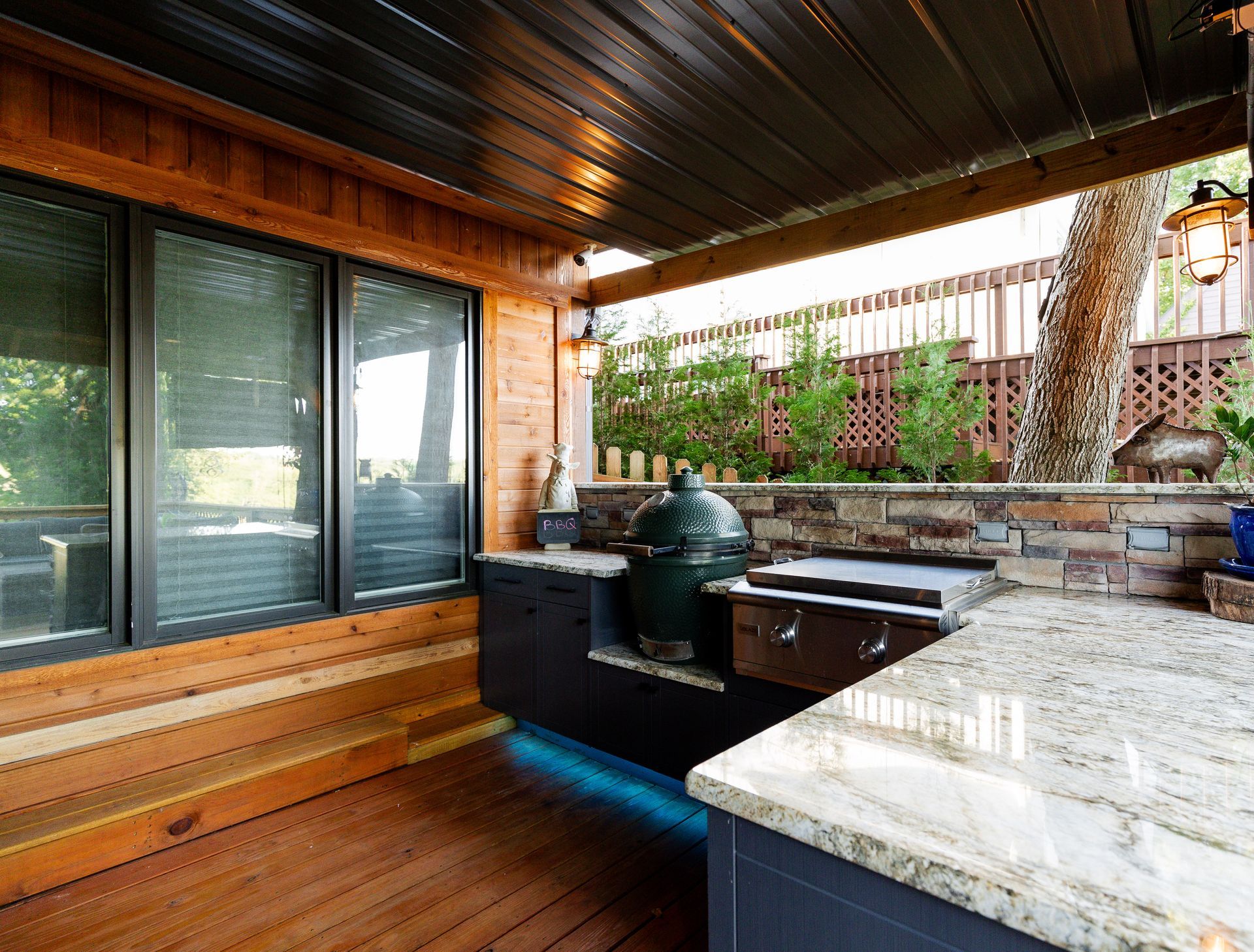 A kitchen with a green egg on the counter and a large window.