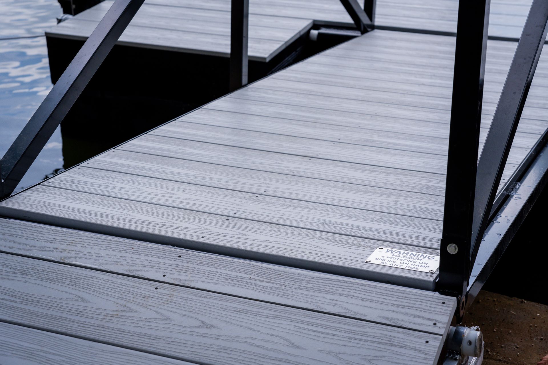 A close up of a dock with stairs leading to the water.