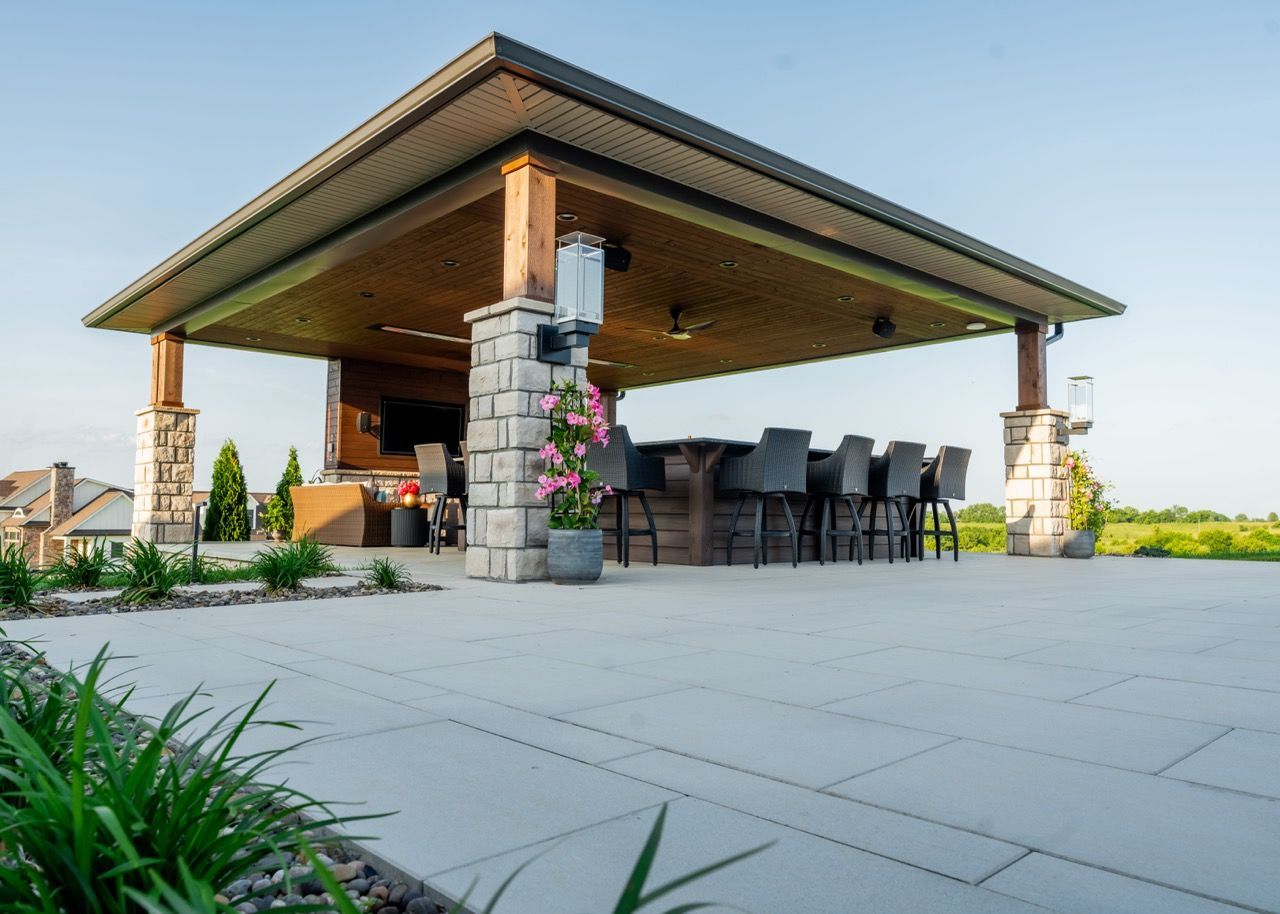A large pavilion with a bar and tables underneath it.