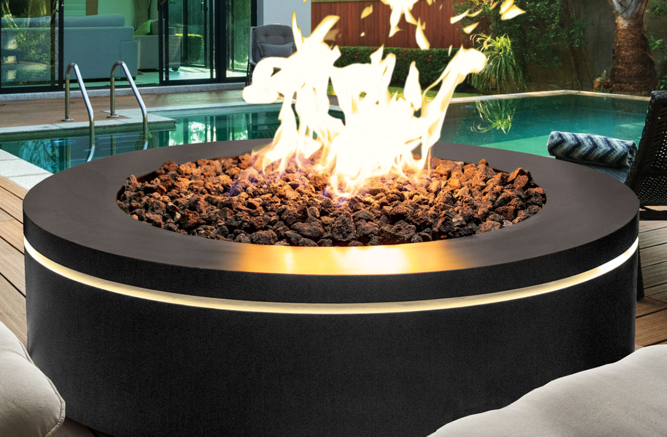 A fire pit is sitting next to a swimming pool