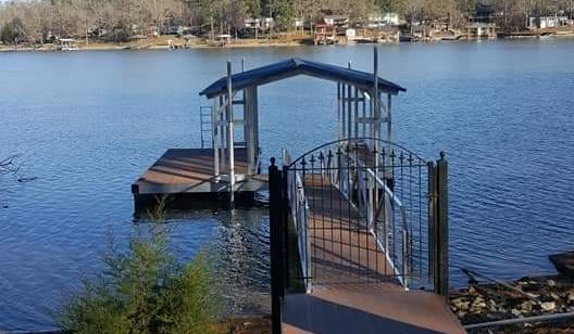 Single slip hip roof boat dock. Hearthstone aluminum decking and gallery blue roof panels - Dock Solutions of Kentucky | Lexington, KY