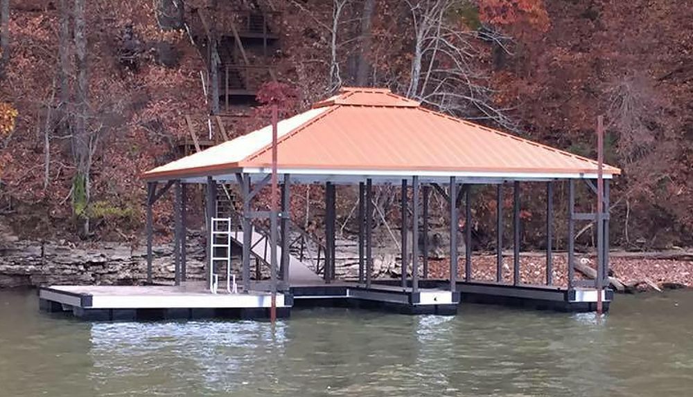 Double slip hip roof boat docks with burnished slate posts and railing, matched perfectly with our copper metallic roof panels - Dock Solutions of Kentucky | Lexington, KY