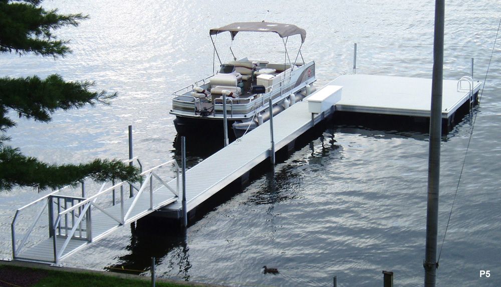 A Pontoon Boat Is at A Dock on A Lake - Dock Solutions of Kentucky | Lexington, KY