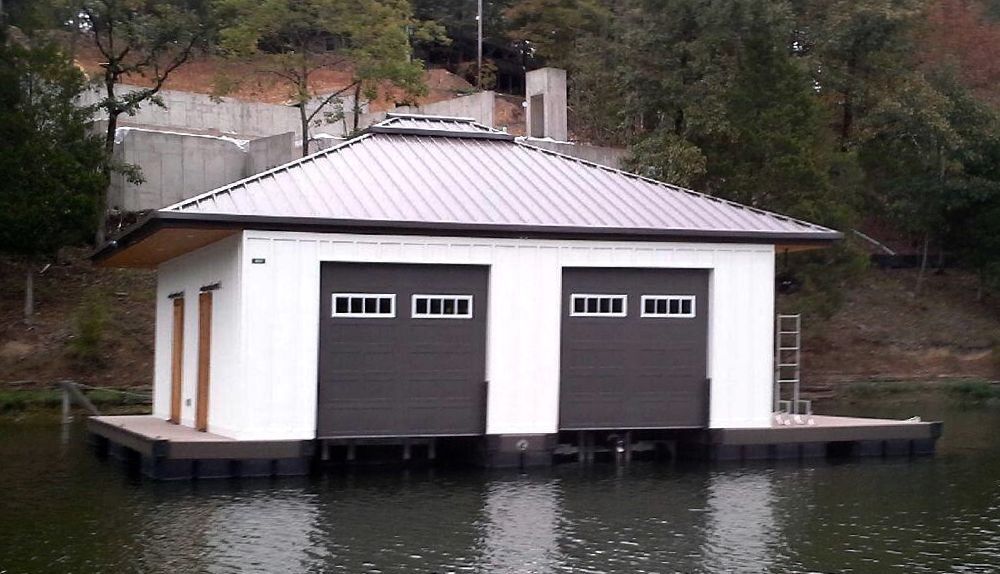 Custom enclosed double slip hip roof boat dock with garage-style slip doors - Dock Solutions of Kentucky | Lexington, KY