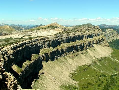 An aerial view of a mountain range with a blue sky