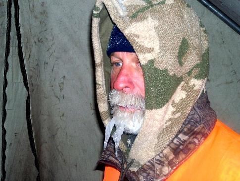 A man with ice on his face wearing a hooded jacket