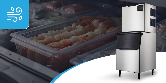 A stainless steel ice machine is sitting next to a container of shrimp.