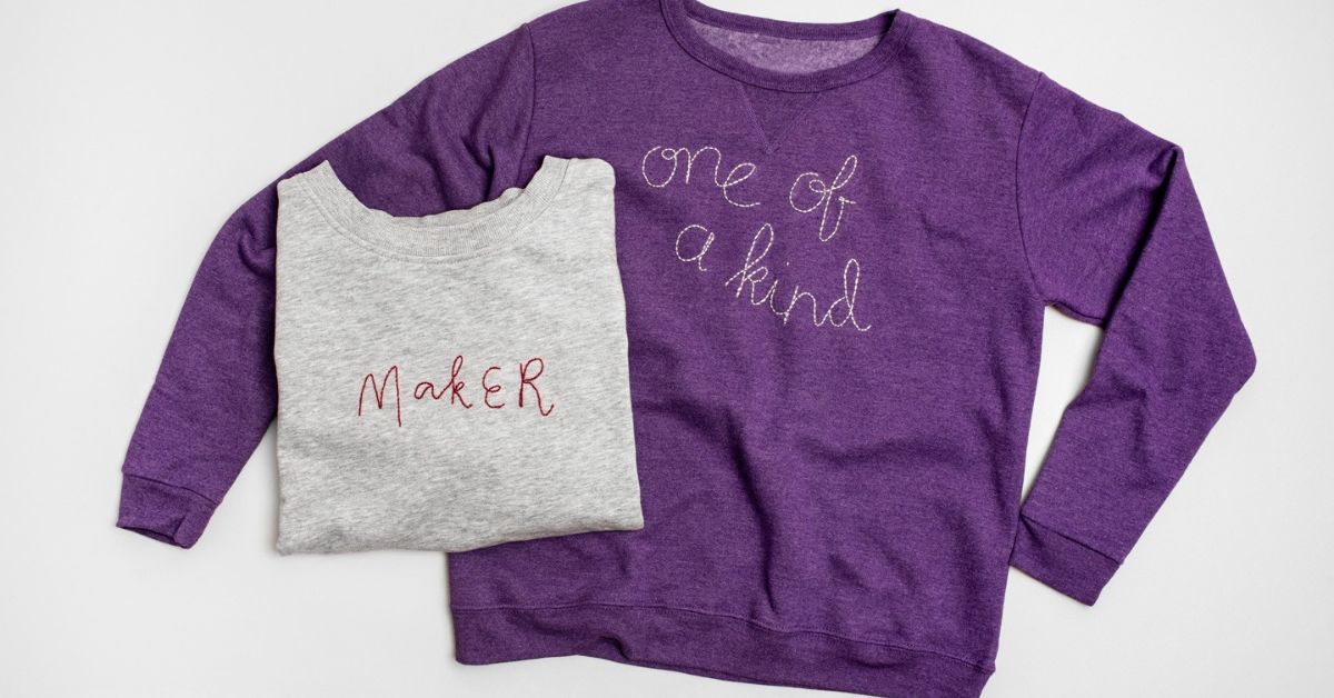 A purple sweater and a grey sweater with the words one of a kind written on them